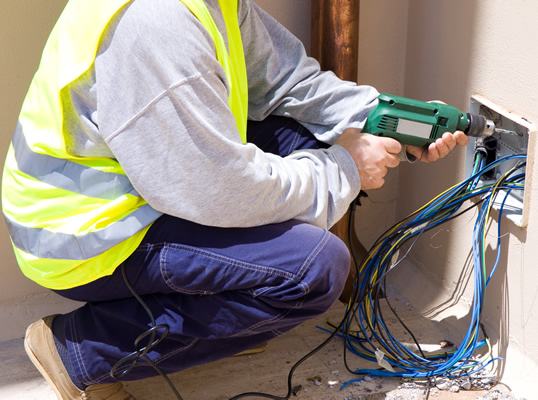 Electrican contractor pulling wires to find short