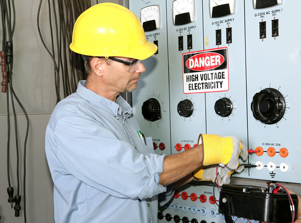 Electrician working on a commercial power distribution center